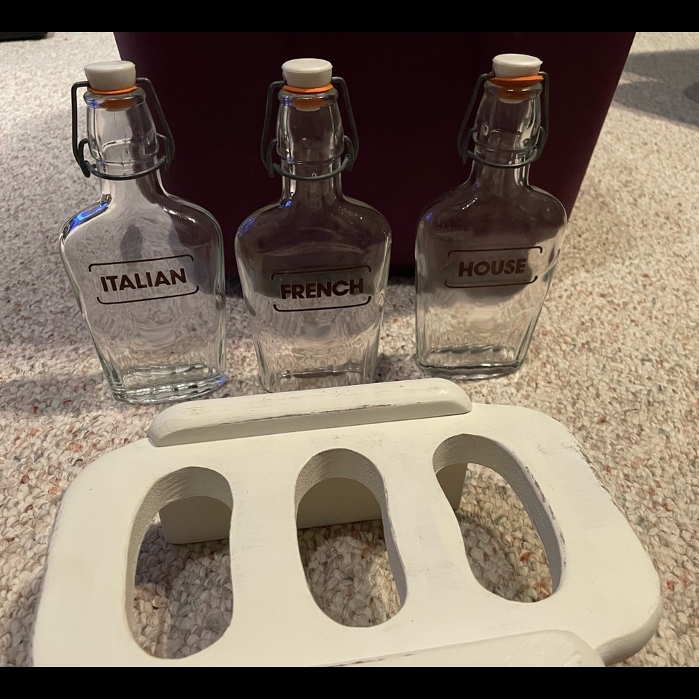 3 old dressing bottles and holder